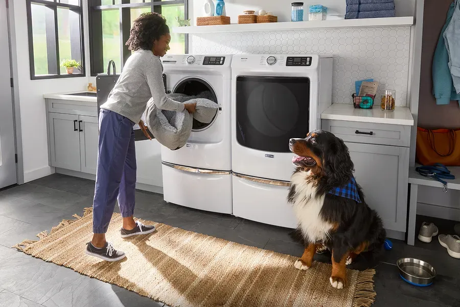 woman-loading-maytag-washer
